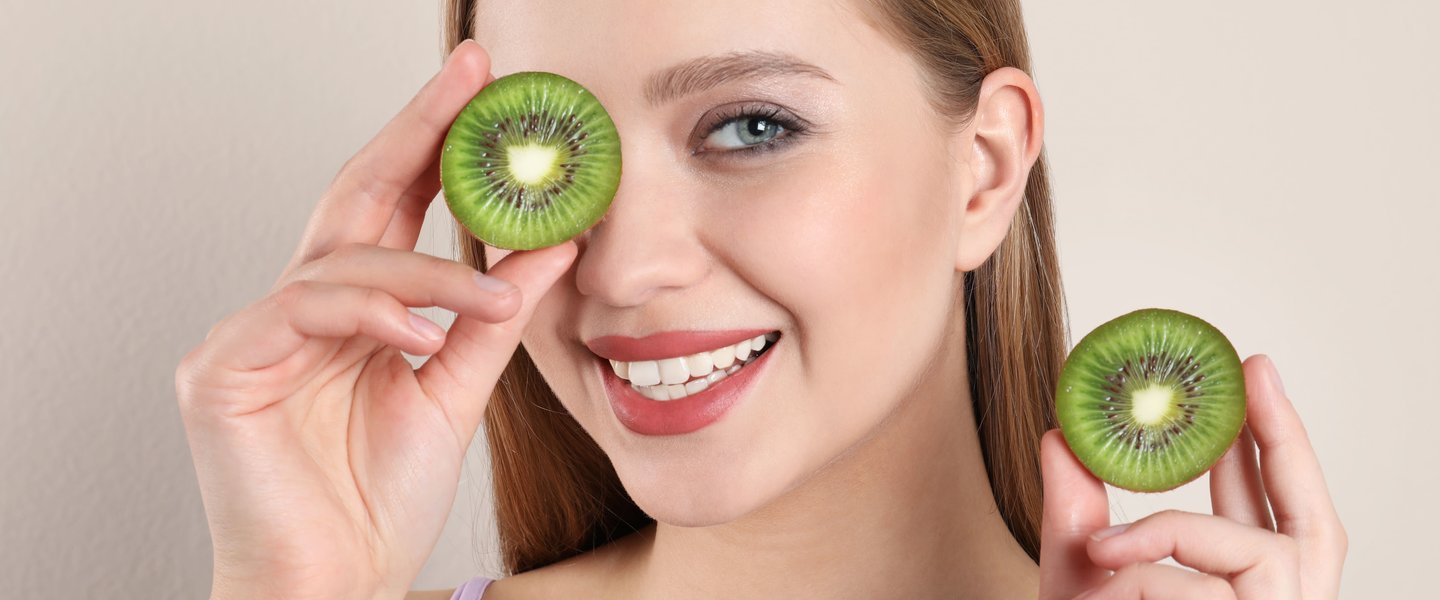 healthy girl with kiwifruit